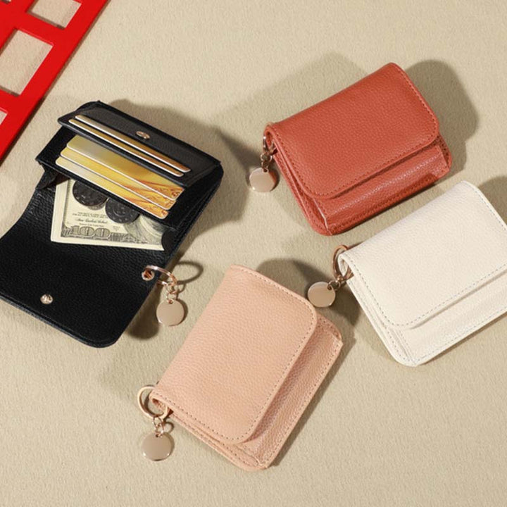 Open view of a women's leather mini coin purse, revealing a functional interior.