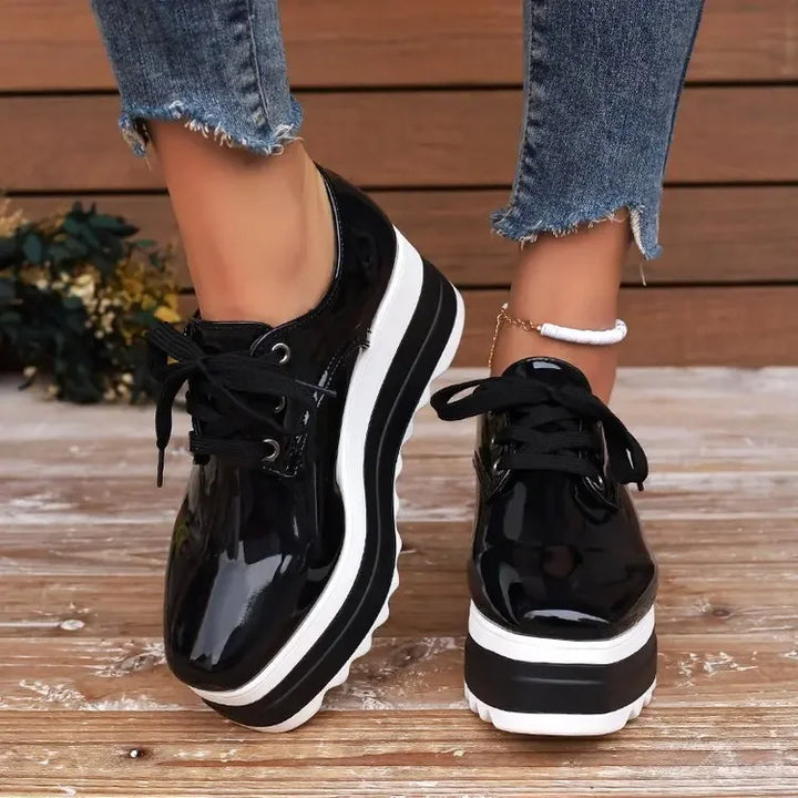 Two women's glossy platform sneakers side-by-side, comparison shot, emphasizing color and material.