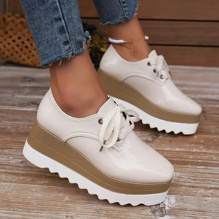 Back view of women's glossy platform sneakers, highlighting heel detailing and durable construction.