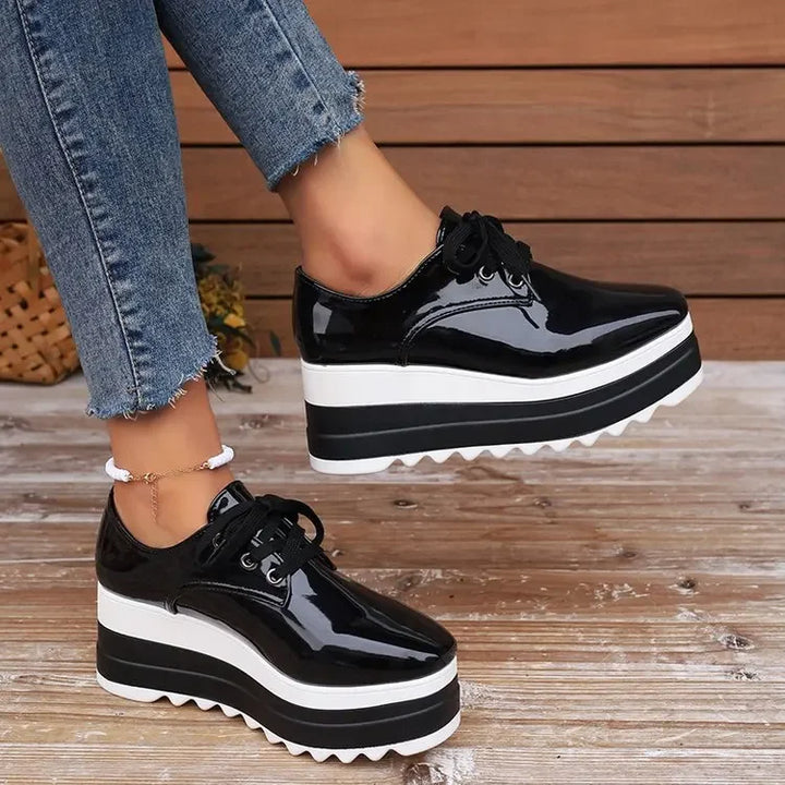 Glossy platform sneakers for women, arranged neatly against a plain background, ready for casual wear.