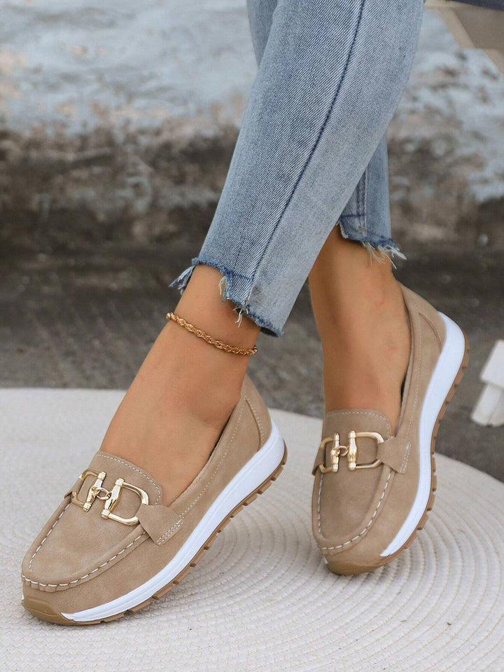 Elegant black women's loafers with gold buckle, versatile flat shoes for dressy or casual wear.