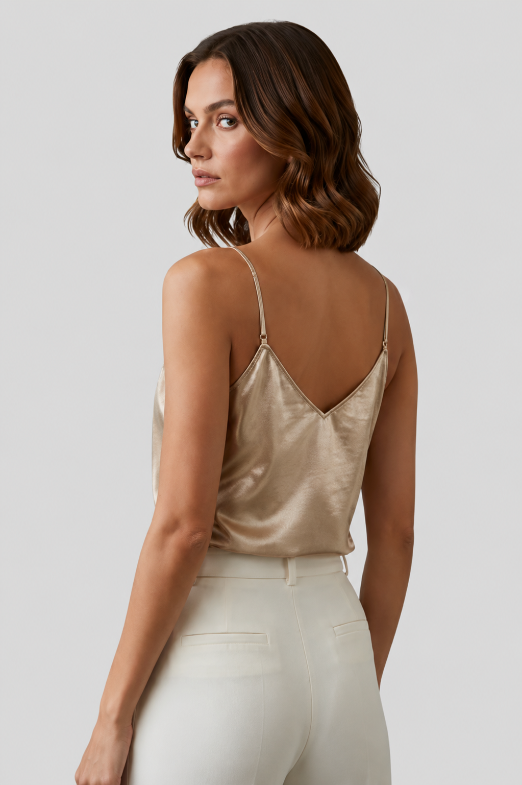 Versatile gold women's tank top with a V-neck and thin straps, ideal for warm weather and chic outfits.