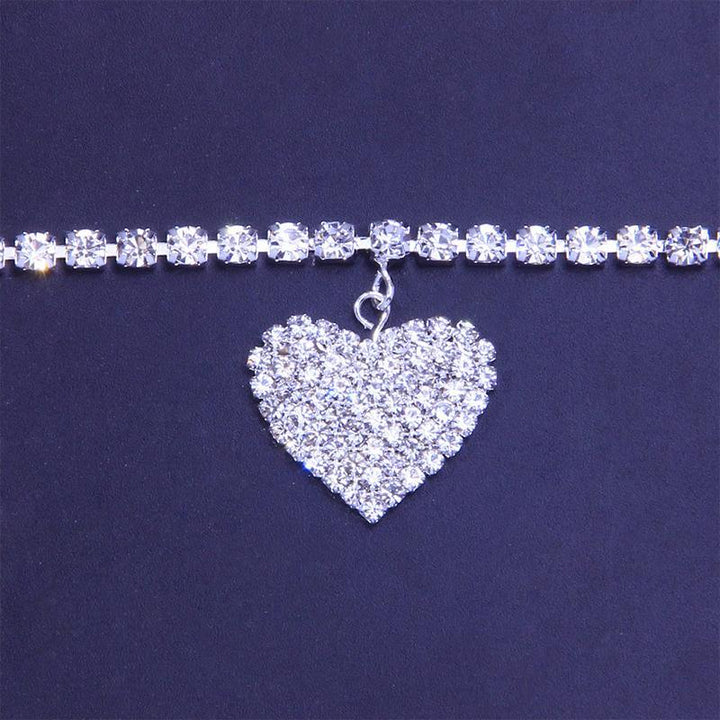 Stylish women's anklet featuring a rhinestone heart charm, available in golden, silver, and copper.