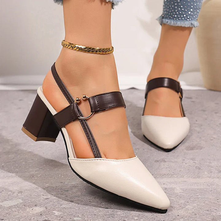 Stylish women's block heels in black leather with a golden ring accent, sophisticated dress shoes.