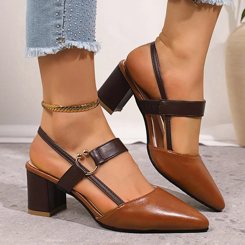 Women's evening shoes: black leather block heels with elegant golden ring accent, fashionable.