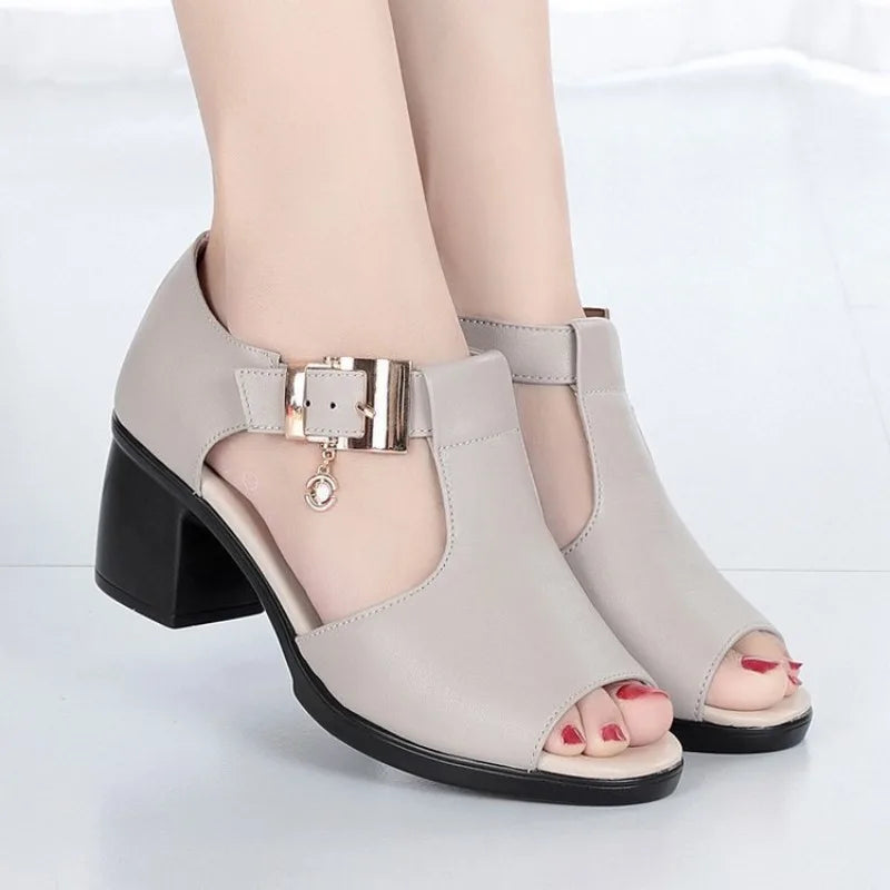 Front view of black open-toe leather heels for women, showcasing the stylish buckle.