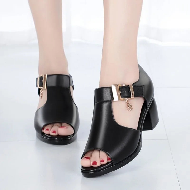 Detail shot of the sturdy block heel on a women's open-toe pump with buckle closure.