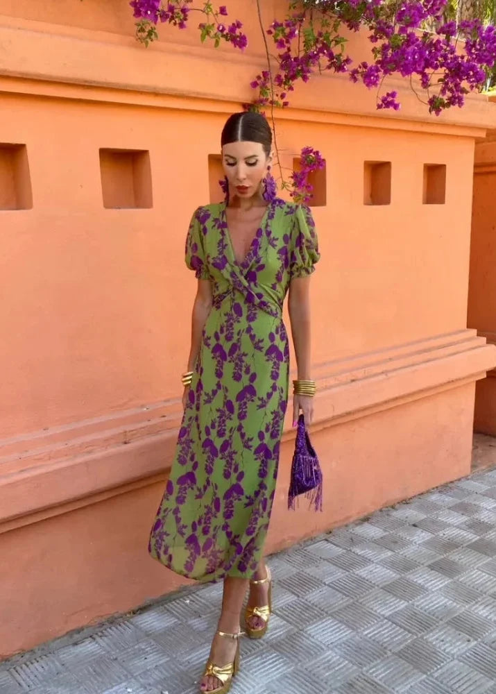 Stylish women's green floral midi dress featuring a flattering wrap V-neck and trendy puff sleeves. A new arrival.