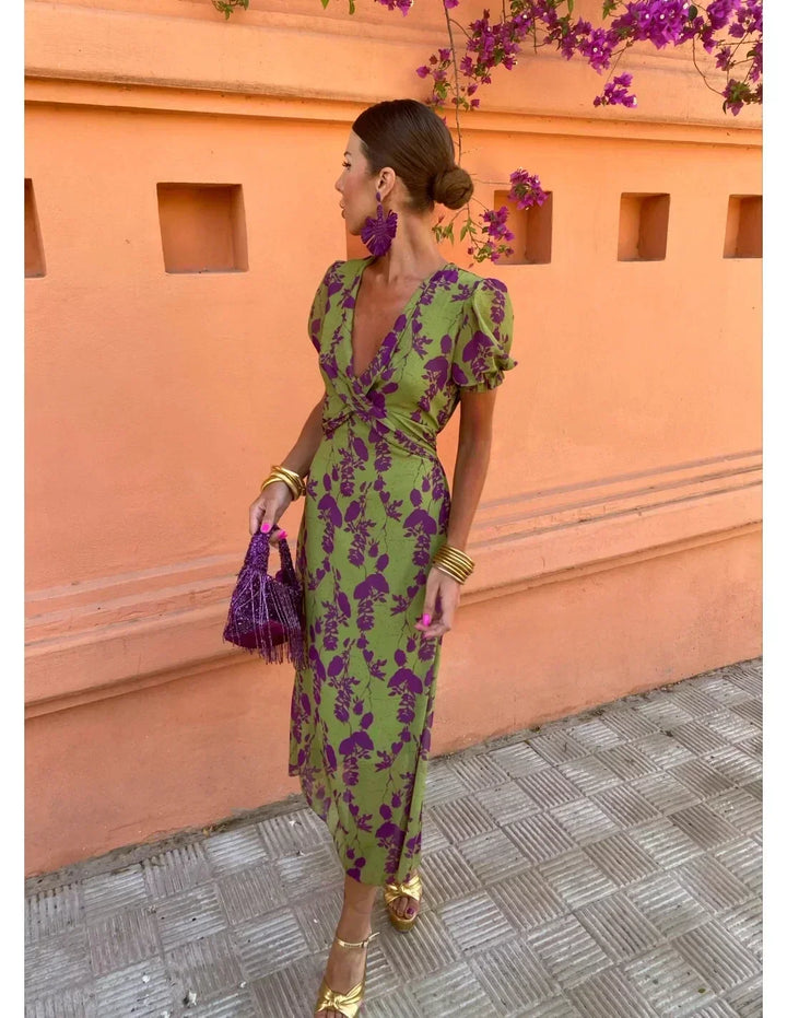 Flowy women's green floral print maxi dress with a flattering wrap V-neck, ideal for casual summer style.