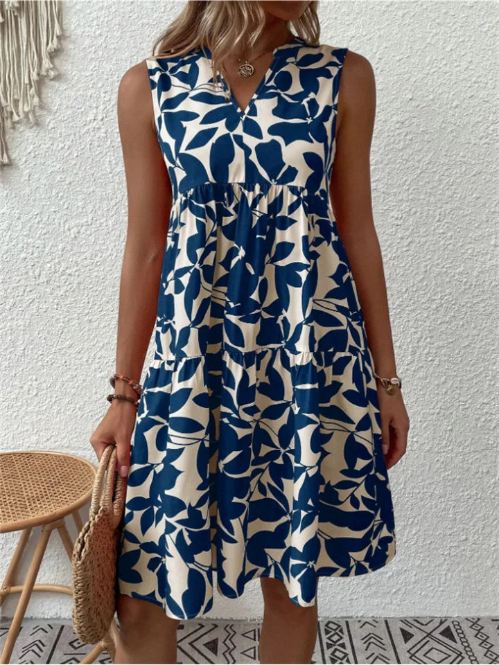 Women's elegant leaf print V-neck mini dress. Sleeveless, tiered design for effortless summer casual or party style.