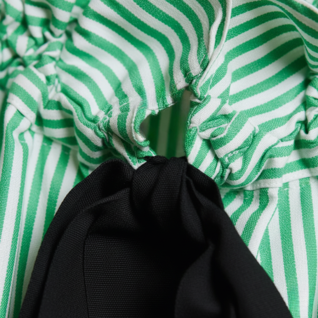 Elegant black striped blouse for women, ideal for office fashion. Features a sophisticated bow tie & ruffled collar.