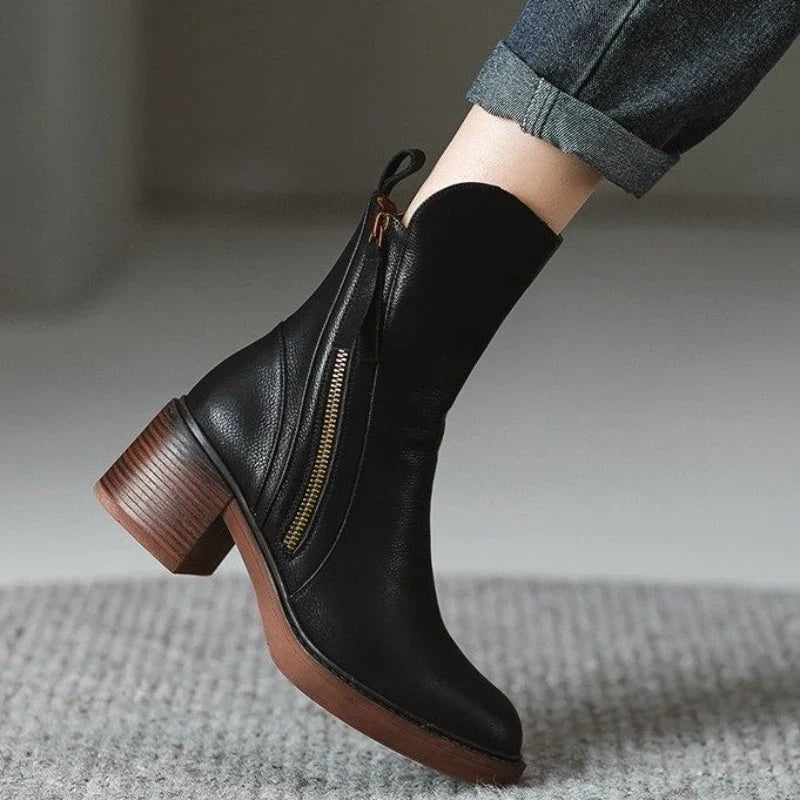 Stylish women's high heel boots; ankle length, zipper closure, and shock-absorbing sole.