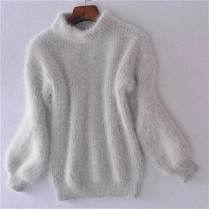 Close-up of a women's soft knit pullover sweater, featuring a stylish high neck design.