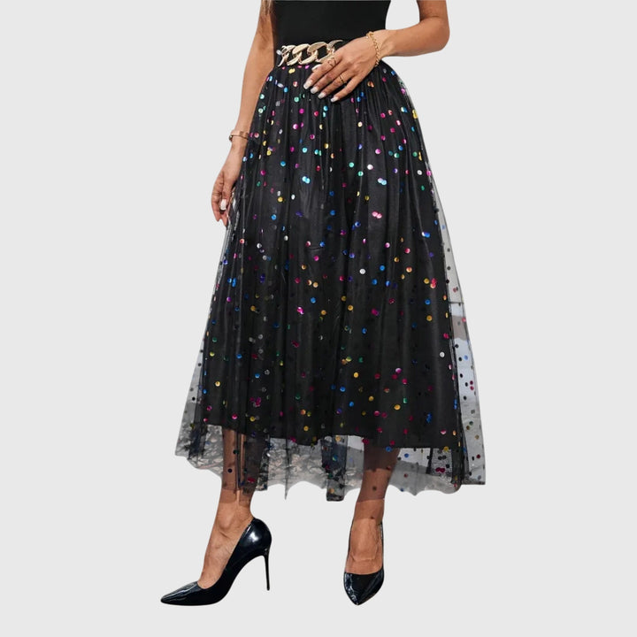 Close-up of sparkling black sequin overlay on a women's high-waist midi skirt, ideal for party and formal events.