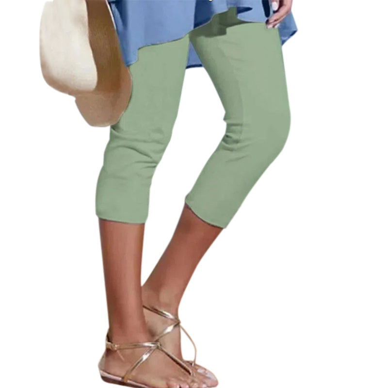 Woman stretching in soft knee-length leggings, suitable for yoga and workouts