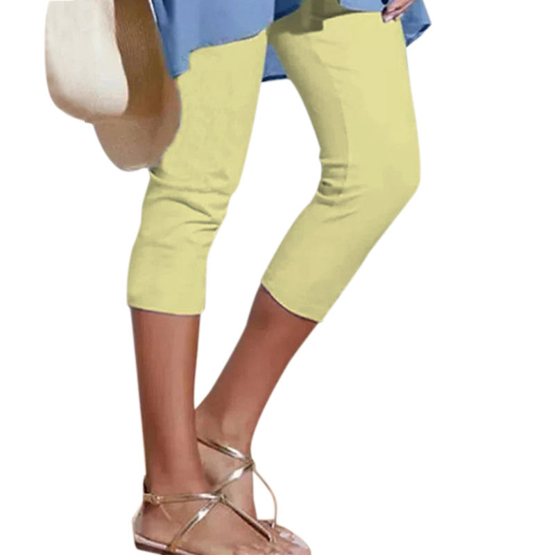 Woman walking outdoors wearing casual knee-length leggings with a high waist