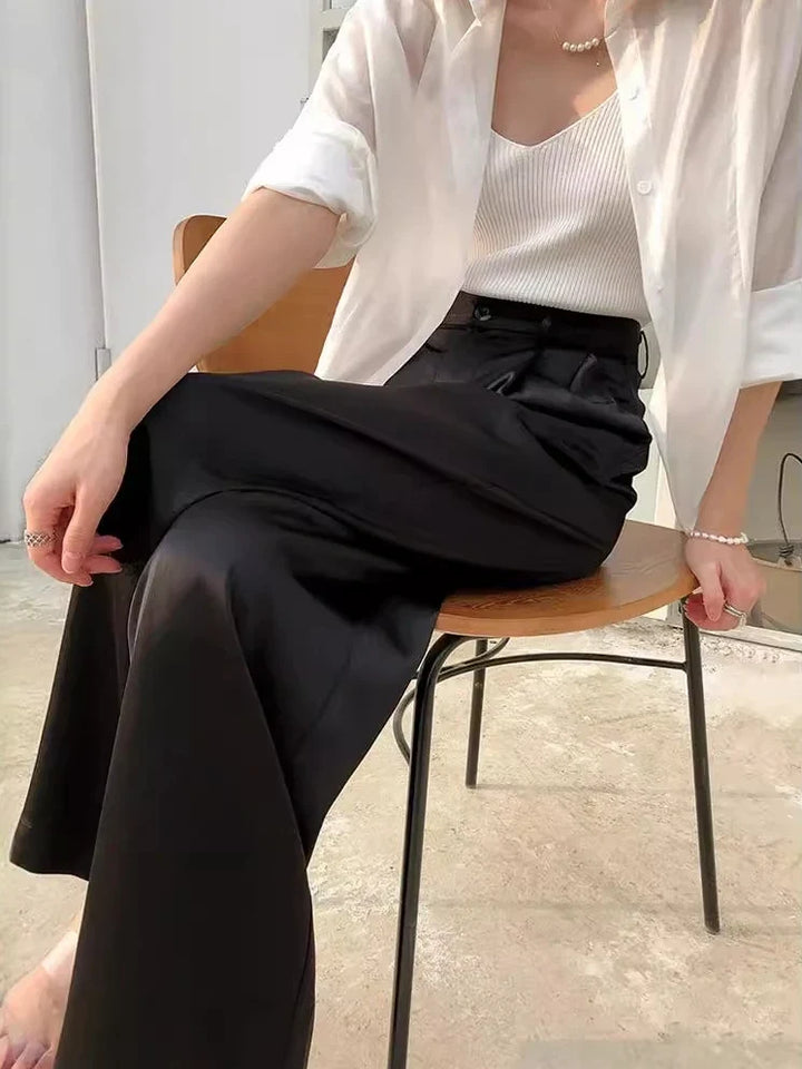 Woman models comfortable high waist wide leg pants, loose fit, perfect for spring outfits.