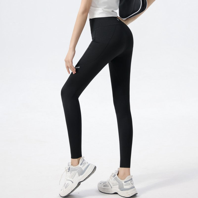 Trendy women's activewear leggings, high-waisted and featuring a fun alphabet shark print.