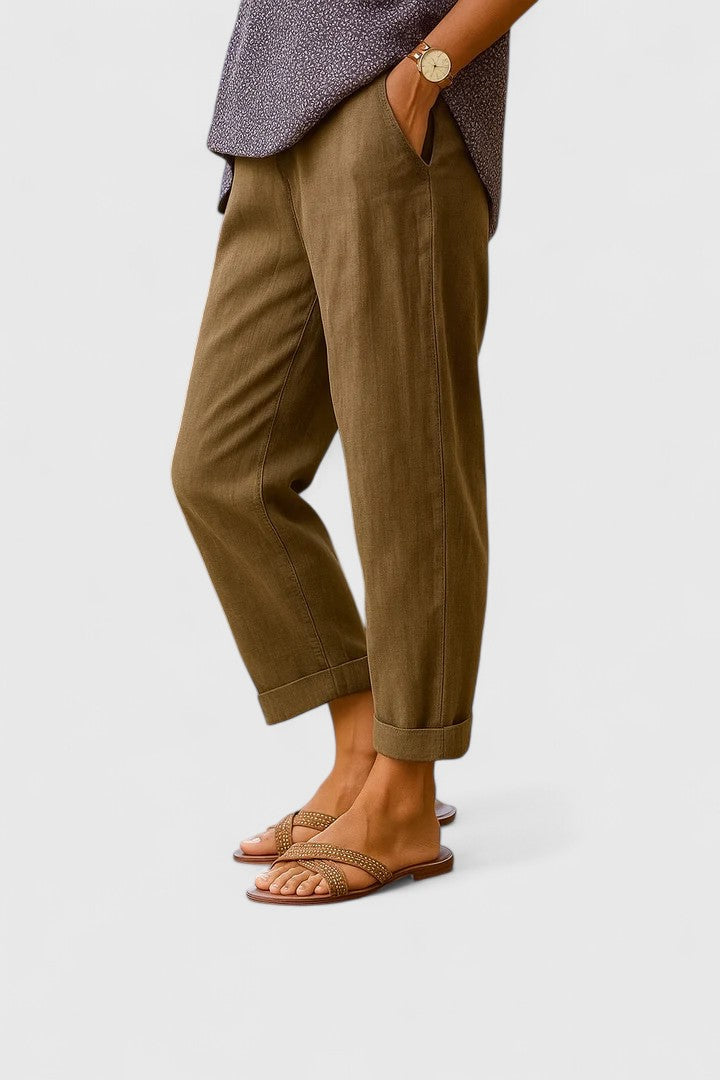 Woman wearing comfortable black tailored straight leg ankle pants, styled for a chic professional or smart casual outfit.