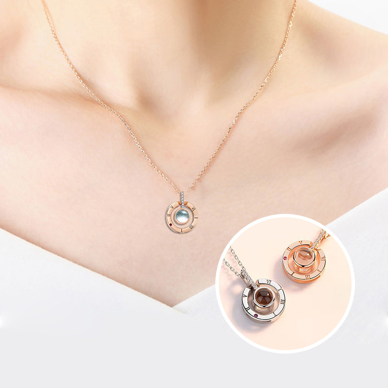 Display of the 'I Love You' message projected from the rose gold heart necklace onto a surface.