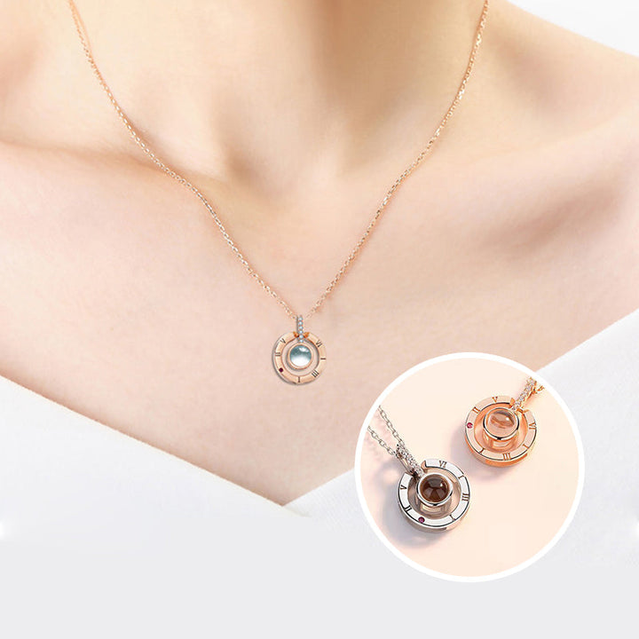 Display of the 'I Love You' message projected from the rose gold heart necklace onto a surface.