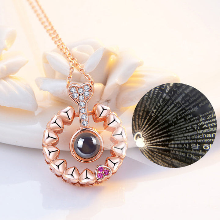 Silver '100 Languages I Love You' necklace, showcasing the beautiful heart-shaped alloy pendant.