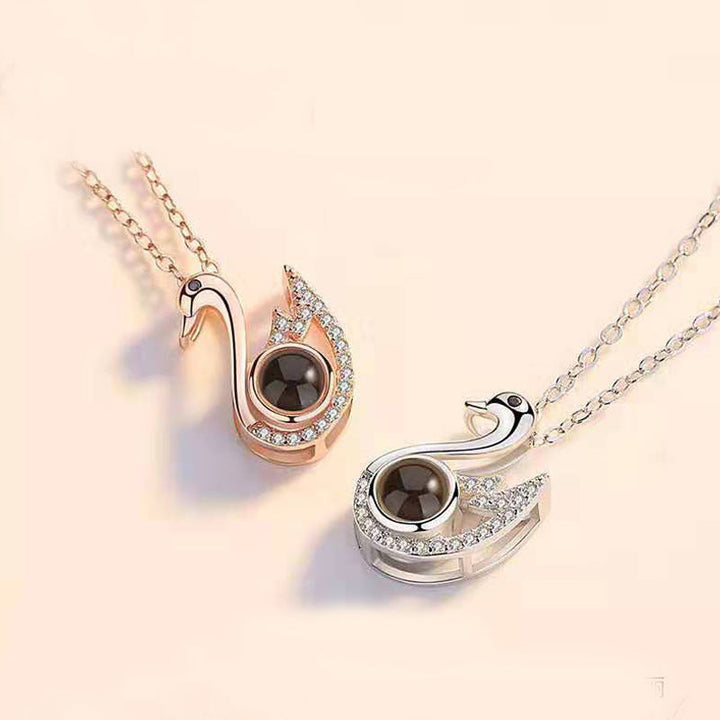 Silver 'I Love You' projection necklace displayed on a white background, highlighting its design.