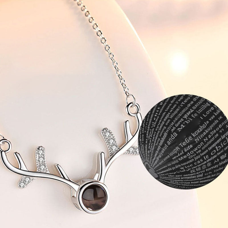 The 'I Love You' message clearly visible when projected from the rose gold necklace pendant.