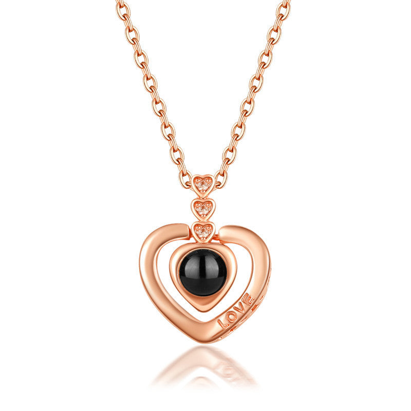 Rose gold 'I Love You' projection necklace, a timeless piece, ideal for a romantic gesture.