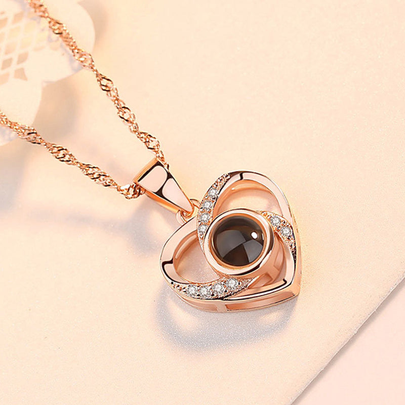 Close-up view of the projection stone within the silver 'I Love You' heart pendant necklace.
