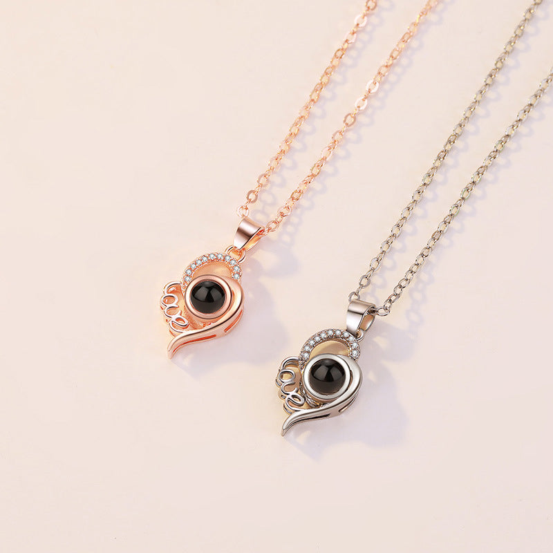 Rose gold 'I Love You' projection necklace, a cherished sentimental gift for women.