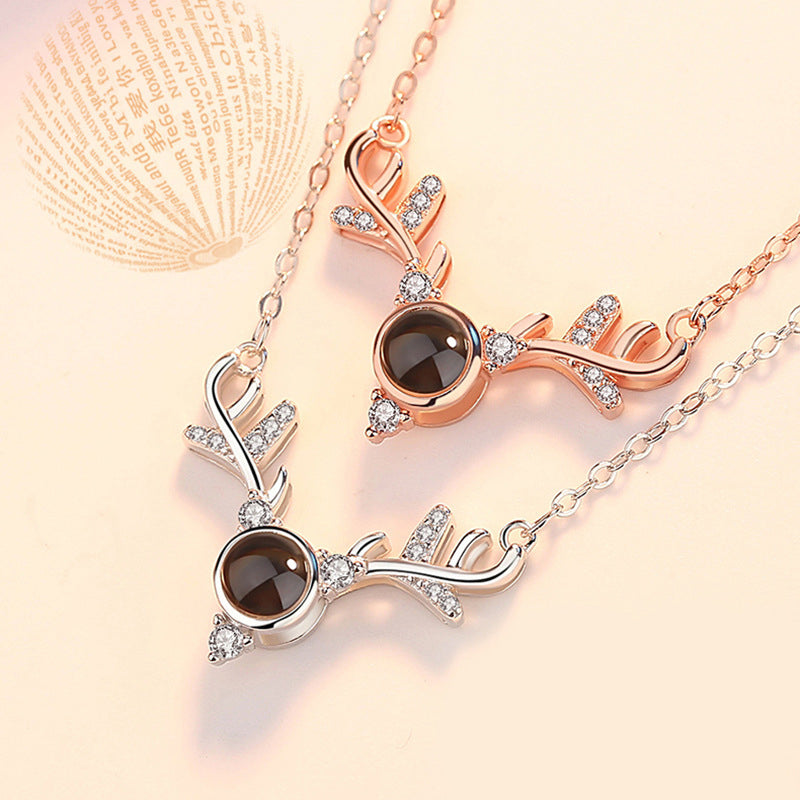 Silver heart pendant necklace displaying 'I Love You' in 100 languages, a sentimental alloy necklace.
