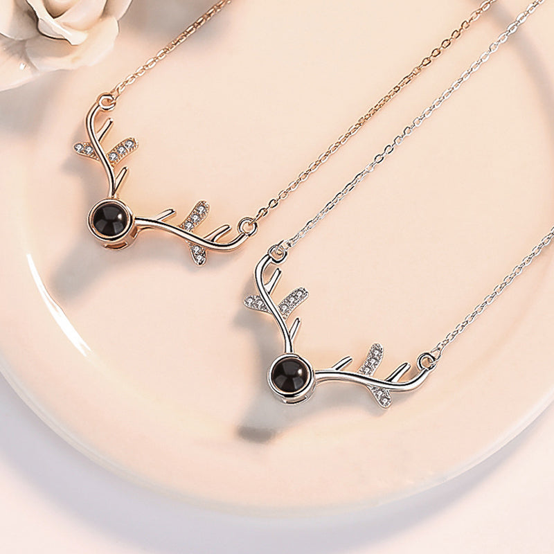Women wearing a delicate rose gold projection necklace, 'I Love You' message, romantic jewelry.