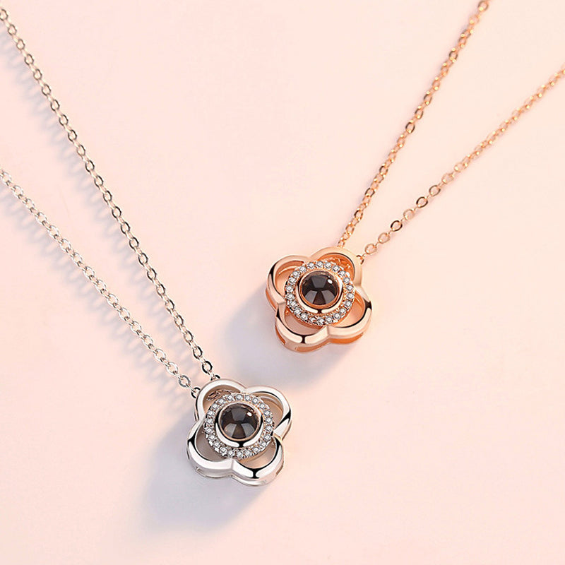 Detailed view of the 'I Love You' projection mechanism within a rose gold heart necklace.