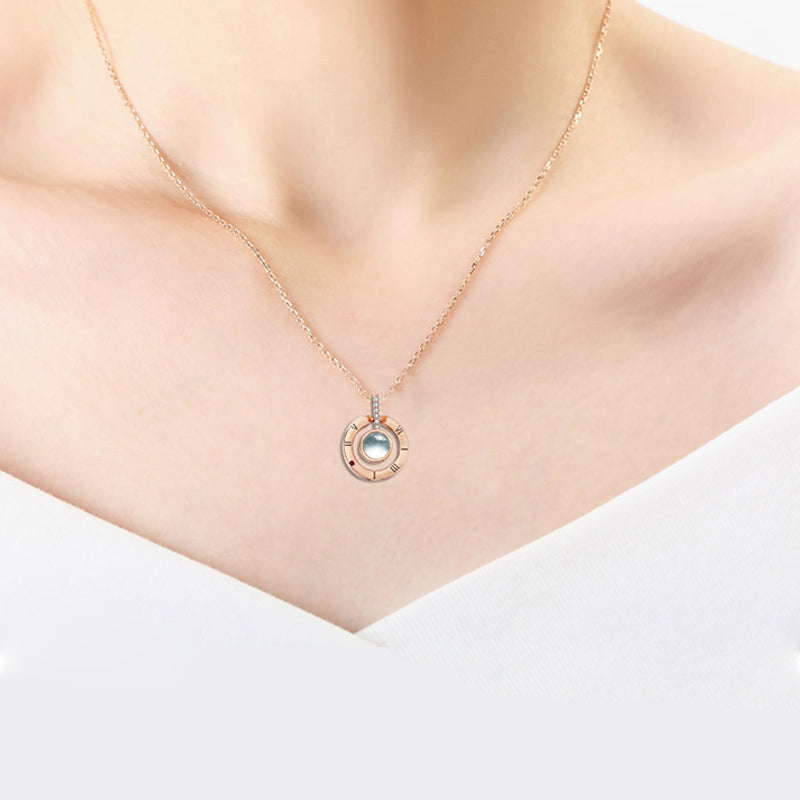 Side profile of a silver '100 Languages I Love You' pendant, showing its fine craftsmanship.