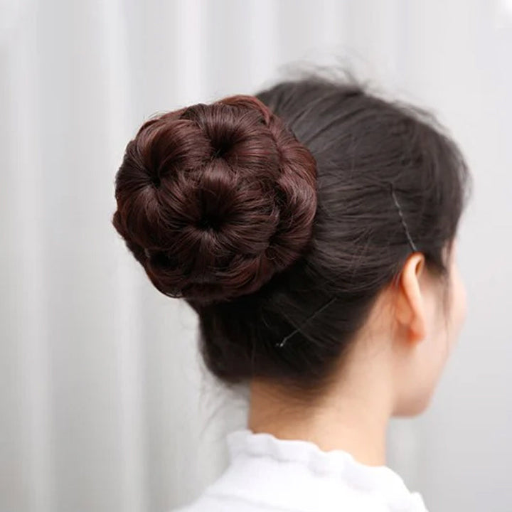 Woman wearing a flower bun hair clip extension, showcasing a chic and easy updo