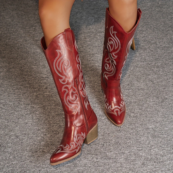 Women's knee-high block heel cowboy boots in a vibrant red color. Pointed toe design.