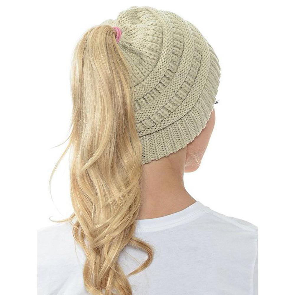 Woman smiling while wearing a comfortable and functional Women's Ponytail Knit Beanie
