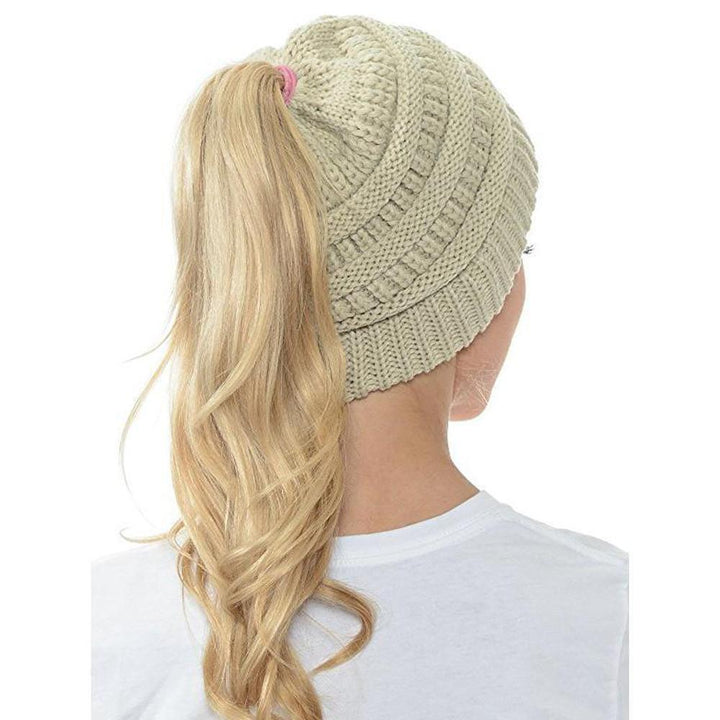 Woman smiling while wearing a comfortable and functional Women's Ponytail Knit Beanie