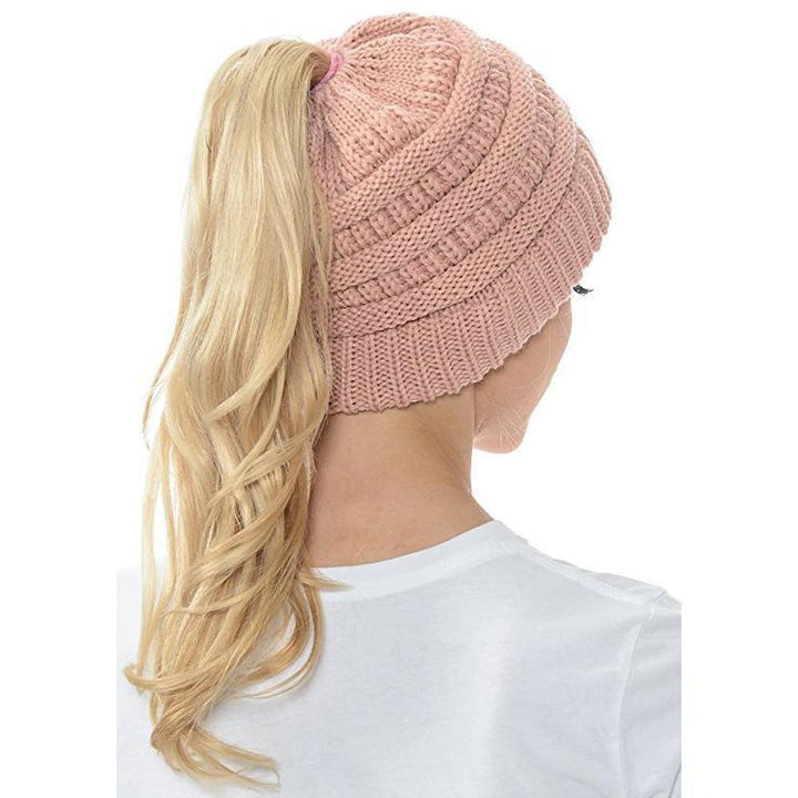 Studio shot of a Women's Knit Ponytail Beanie Hat, displaying its soft and stretchy material