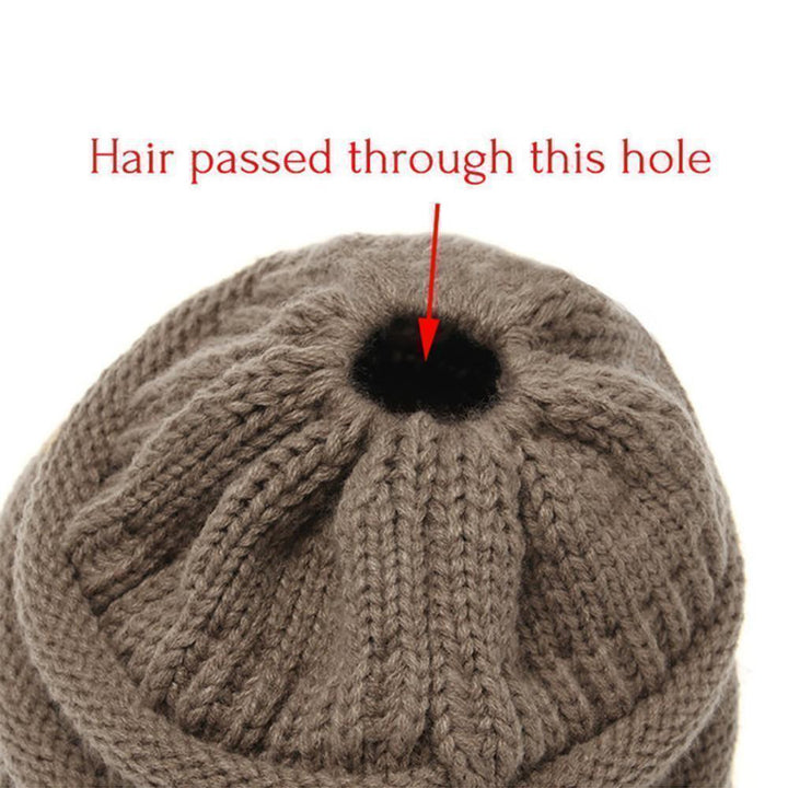 Overhead view of a Women's Knit Ponytail Beanie, emphasizing its cozy and warm feel