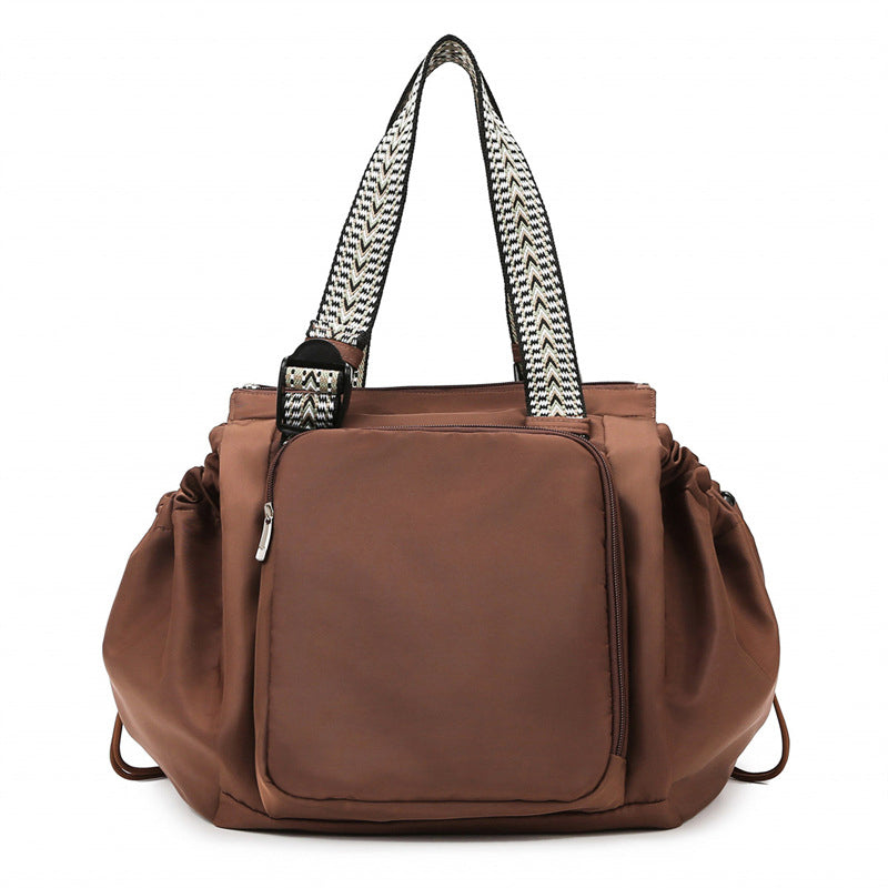 Front view of black nylon women's convertible bag, tote and backpack modes