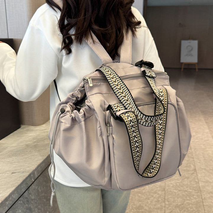 Detail of the zipper closure on women's large tote backpack, durable nylon