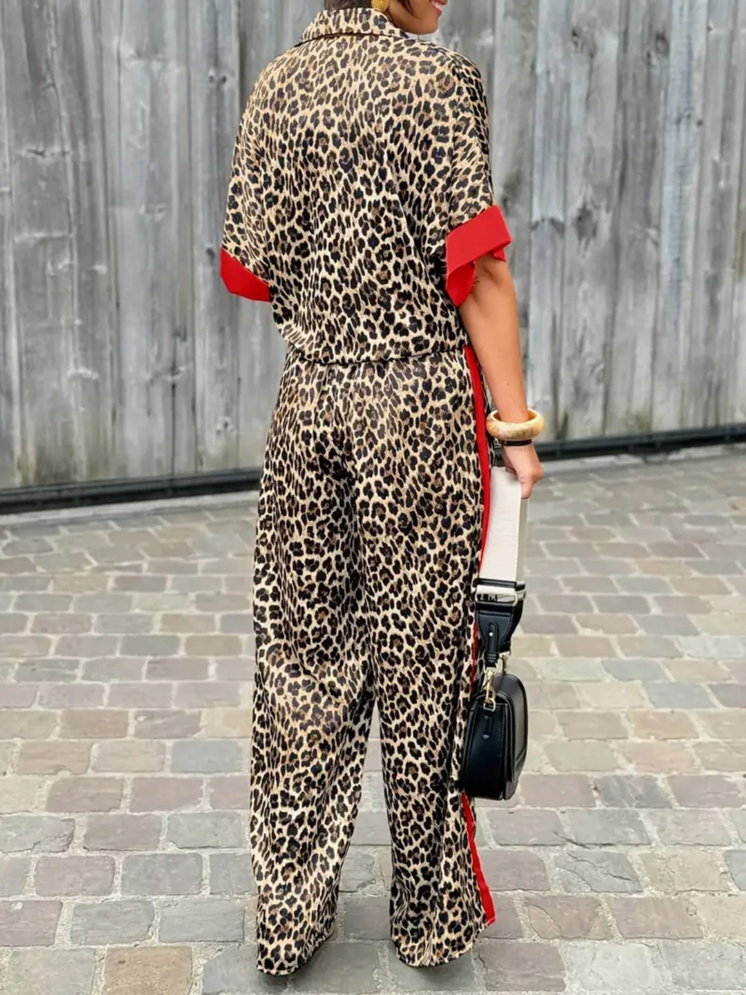 Fashionable women's short sleeve v-neck leopard print jumpsuit featuring a chic wide leg design.