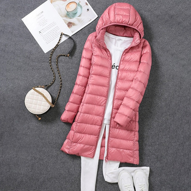 Durable women's long puffer winter coat, designed for warmth, wind and water resistance, essential outerwear.