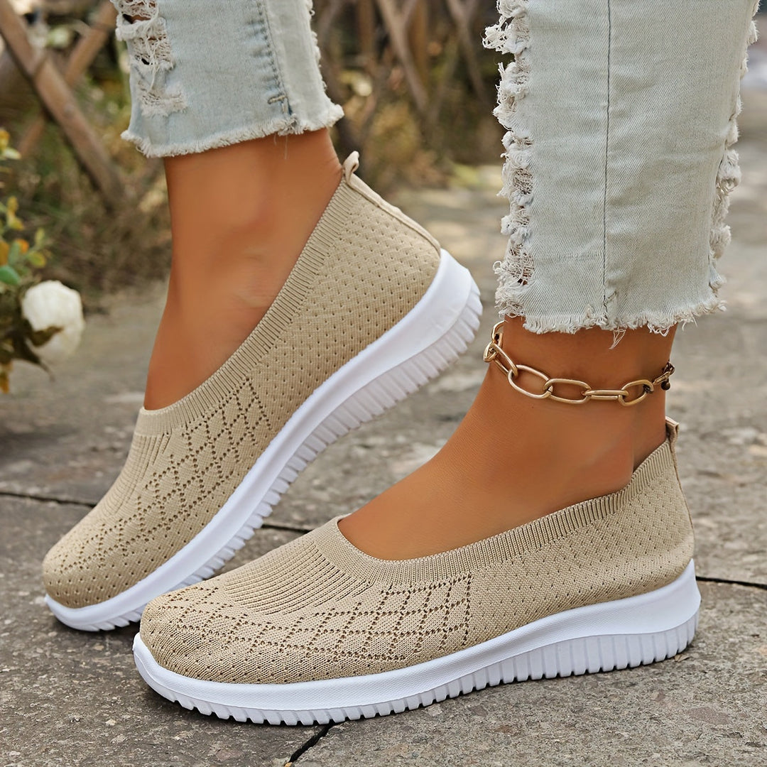 Comfortable women's slip-on walking shoes. Lightweight design with flexible sole for everyday athletic wear.