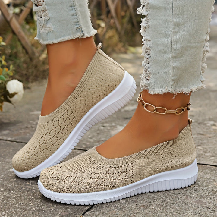 Comfortable women's slip-on walking shoes. Lightweight design with flexible sole for everyday athletic wear.
