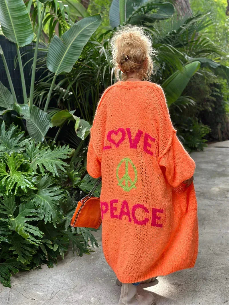 Relaxed fit long knit cardigan for women. A vibrant bohemian statement piece with peace symbol detail.