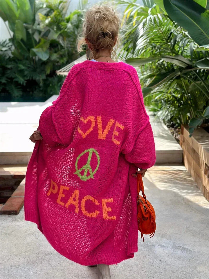 Women's long oversized bohemian knit cardigan featuring a distinctive peace symbol.