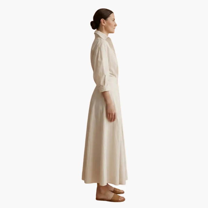 Ankle-length women's button-front shirt dress. Defined waist creates a chic, flowy silhouette.